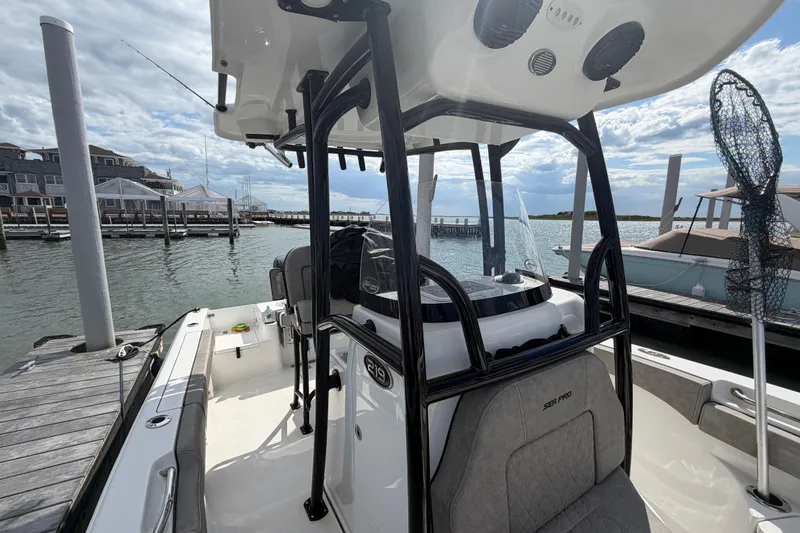 Slide: The Image of 2022 Sea Pro 219 Deep V CC boat docked at marina under cloudy sky. - 11