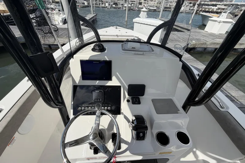 Slide: The Image of 2022 Sea Pro 219 Deep V CC boat console with steering wheel and navigation equipment. - 15