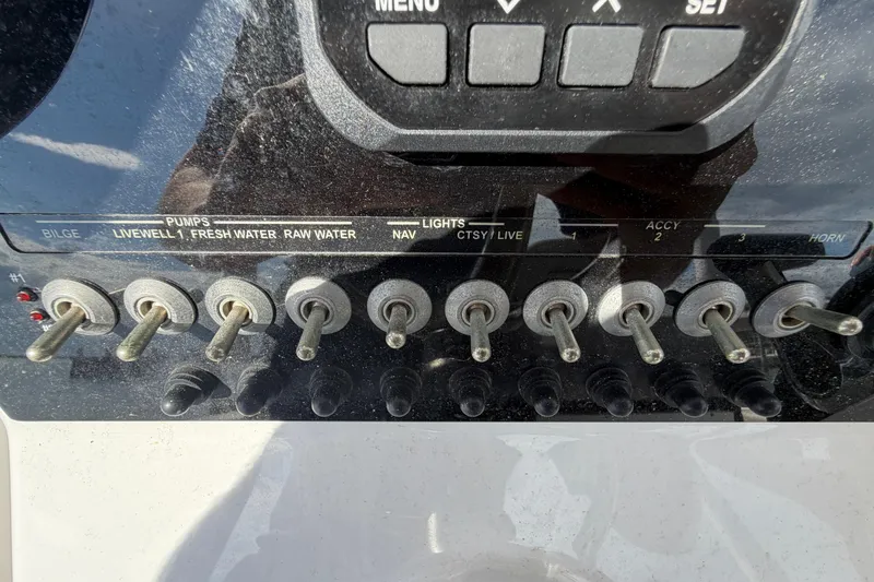 Slide: The Image of Control panel of a 2022 Sea Pro 219 Deep V CC boat with labeled switches. - 17