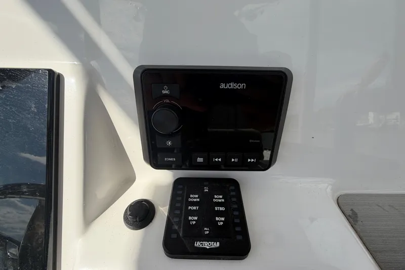 Slide: The Image of Control panel on 2022 Sea Pro 219 Deep V CC boat featuring Audison and Lectrotab systems. - 19