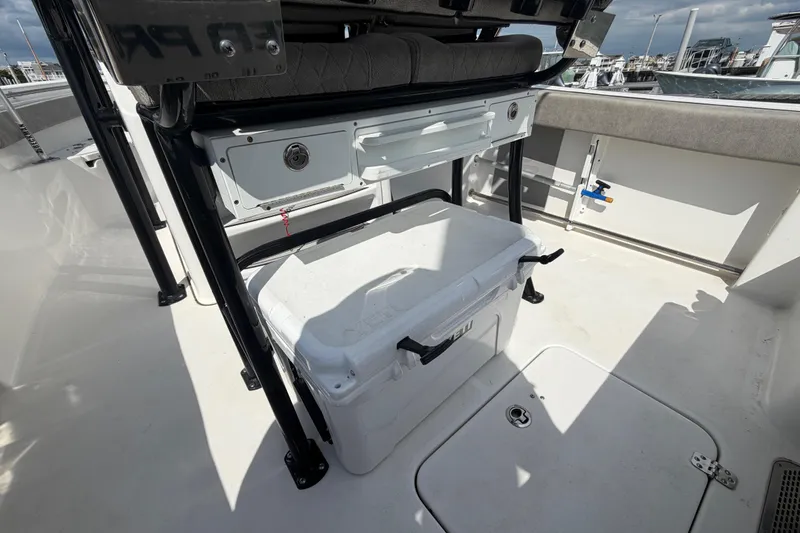 Slide: The Image of 2022 Sea Pro 219 Deep V CC boat interior with storage and cooler. - 21
