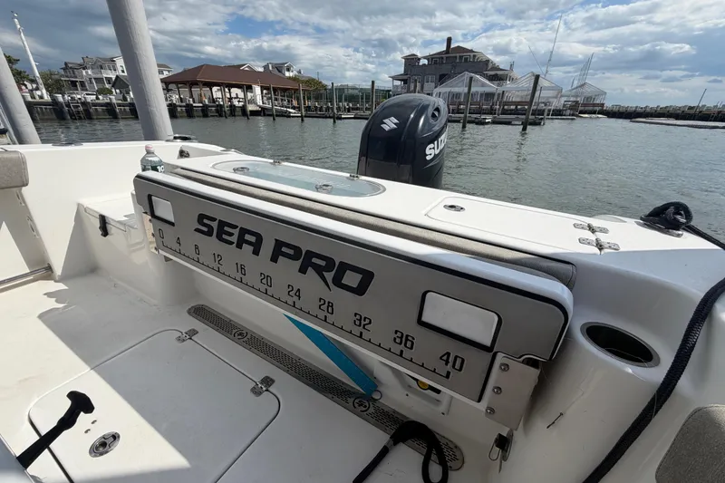 Slide: The Image of 2022 Sea Pro 219 Deep V CC boat with Suzuki engine at a marina dock. - 22