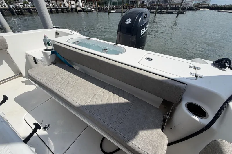 Slide: The Image of 2022 Sea Pro 219 Deep V CC boat interior with seating and Suzuki outboard motor. - 23