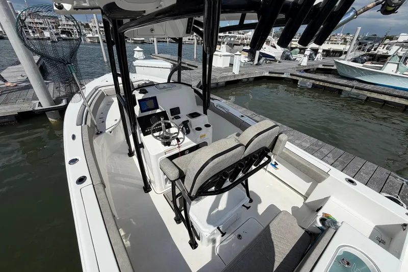 Slide: The Image of 2022 Sea Pro 219 Deep V CC boat docked at marina, featuring modern console and seating. - 24