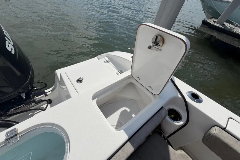 Slide: The Image of 2022 Sea Pro 219 Deep V CC boat with open storage compartment by the water. - 25