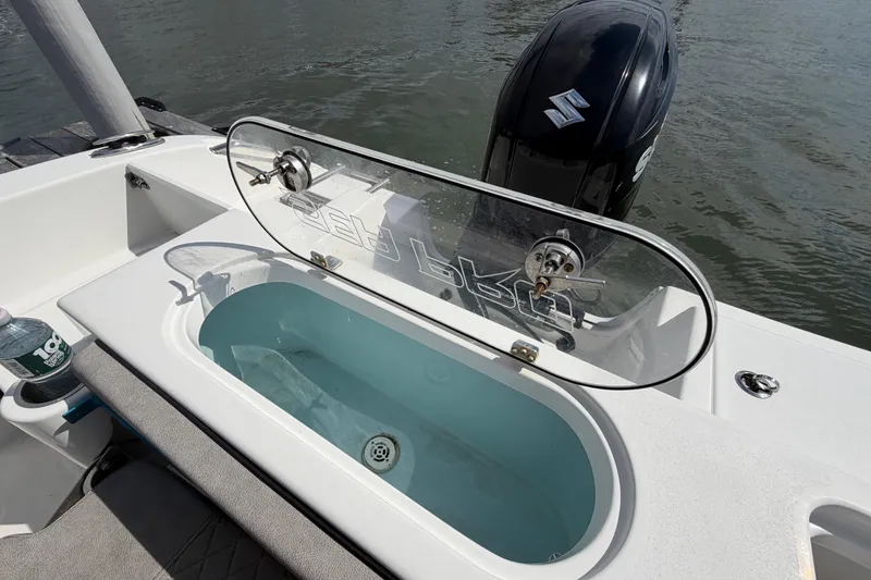 Slide: The Image of 2022 Sea Pro 219 Deep V CC boat with open livewell and Suzuki outboard motor. - 26