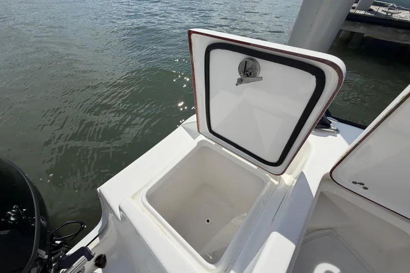 Slide: The Image of Open storage compartment on 2022 Sea Pro 219 Deep V CC boat by the water. - 27
