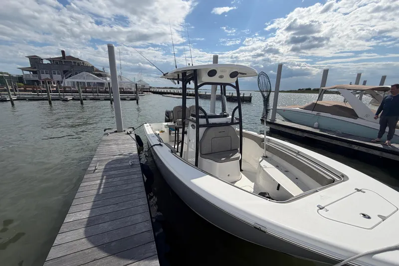 Slide: The Image of 2022 Sea Pro 219 Deep V CC boat docked at marina under cloudy sky. - 3