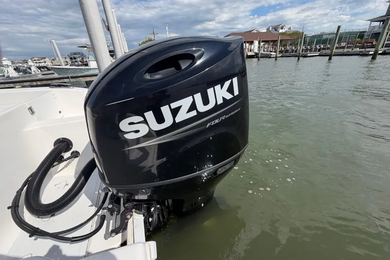 Slide: The Image of 2022 Sea Pro 219 Deep V CC with Suzuki outboard motor in marina setting. - 30