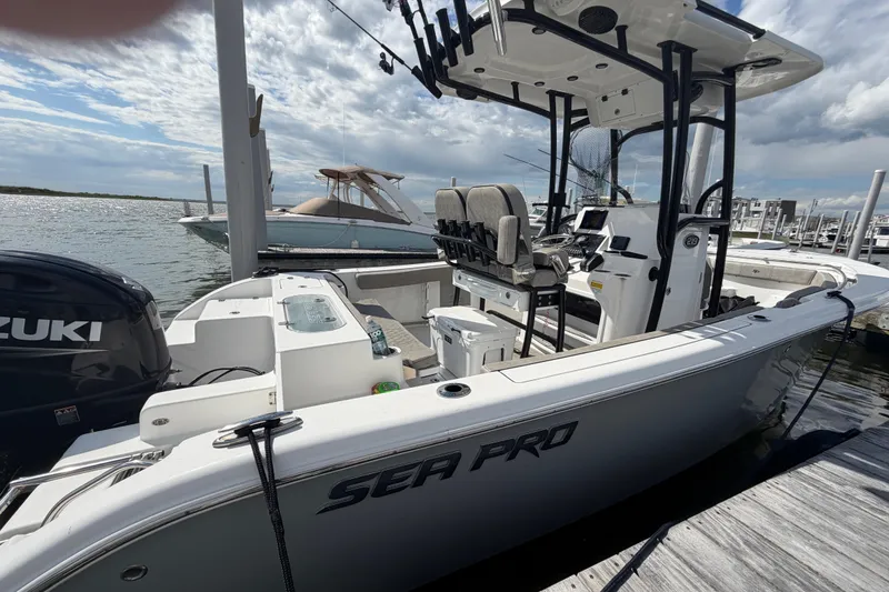 Slide: The Image of 2022 Sea Pro 219 Deep V CC boat docked, featuring Suzuki engine and spacious deck. - 4