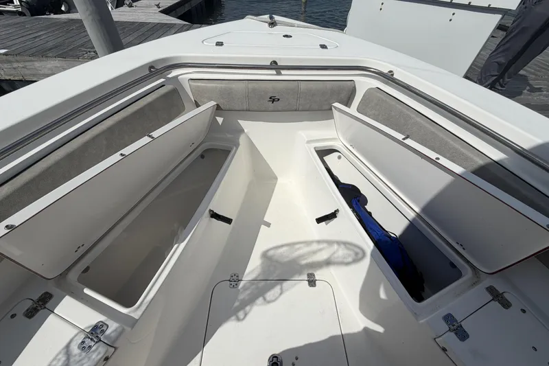 Slide: The Image of 2022 Sea Pro 219 Deep V CC boat with open storage compartments at the bow. - 8