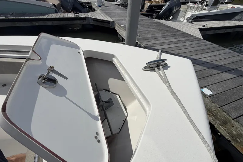 Slide: The Image of 2022 Sea Pro 219 Deep V CC boat with open anchor hatch at dock. - 9