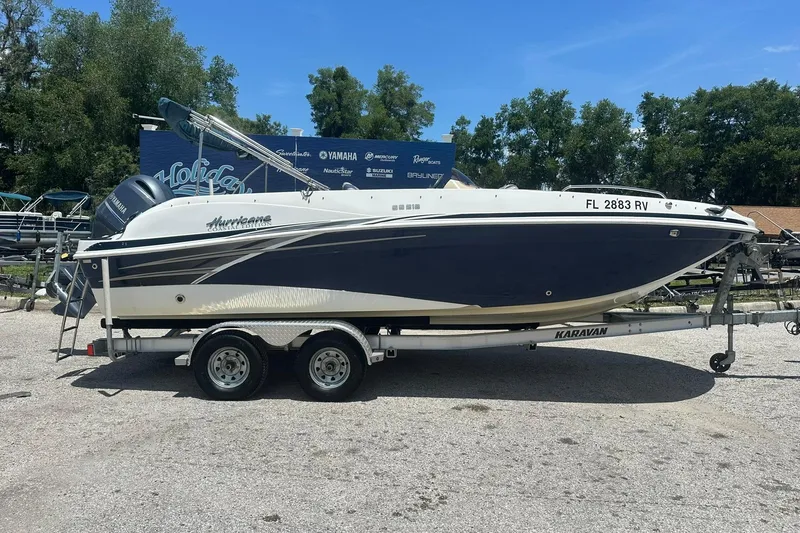 The Image of 2019 Hurricane Sundeck Sport 218 OB boat on trailer, parked outdoors. - 0