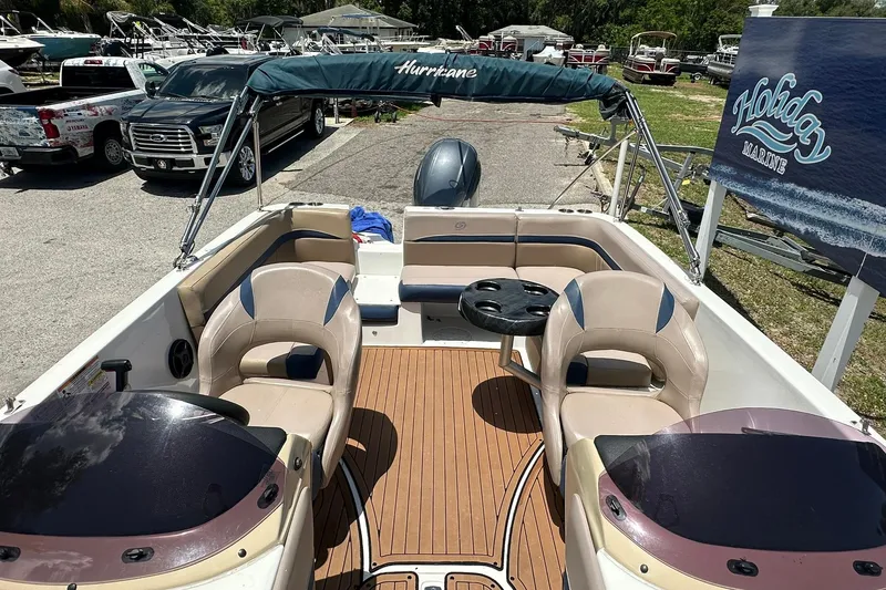 Slide: The Image of 2019 Hurricane Sundeck Sport 218 OB boat interior with seating and steering wheel. - 13