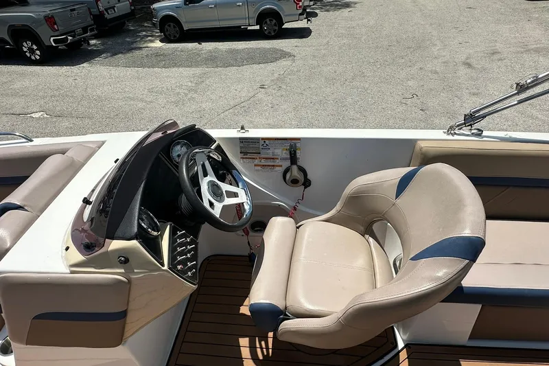 Slide: The Image of 2019 Hurricane Sundeck Sport 218 OB boat interior with steering wheel and seating. - 14