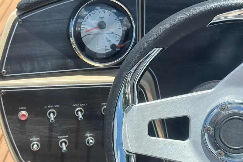 Slide: The Image of Dashboard of 2019 Hurricane Sundeck Sport 218 OB boat with steering wheel and controls. - 16