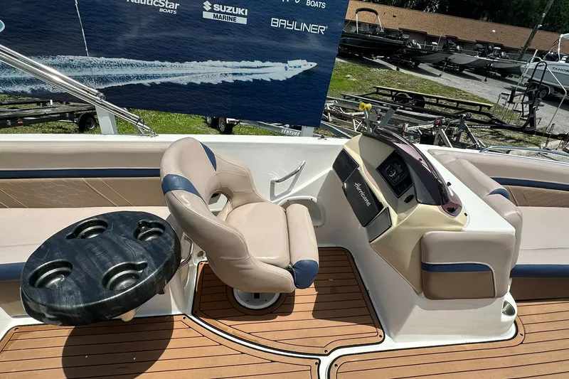 Slide: The Image of 2019 Hurricane Sundeck Sport 218 OB boat interior with helm, seating, and cup holders. - 18