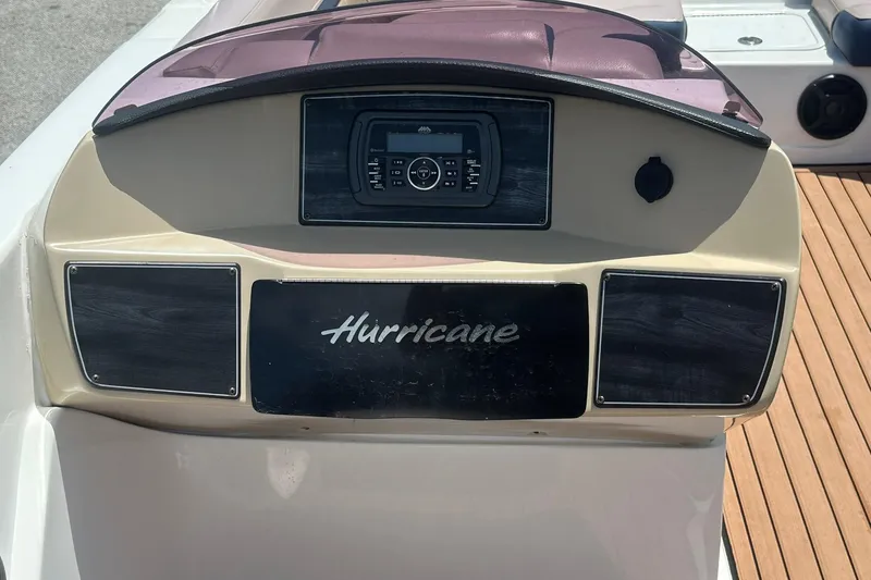 Slide: The Image of 2019 Hurricane Sundeck Sport 218 OB dashboard with control panel and branding. - 19