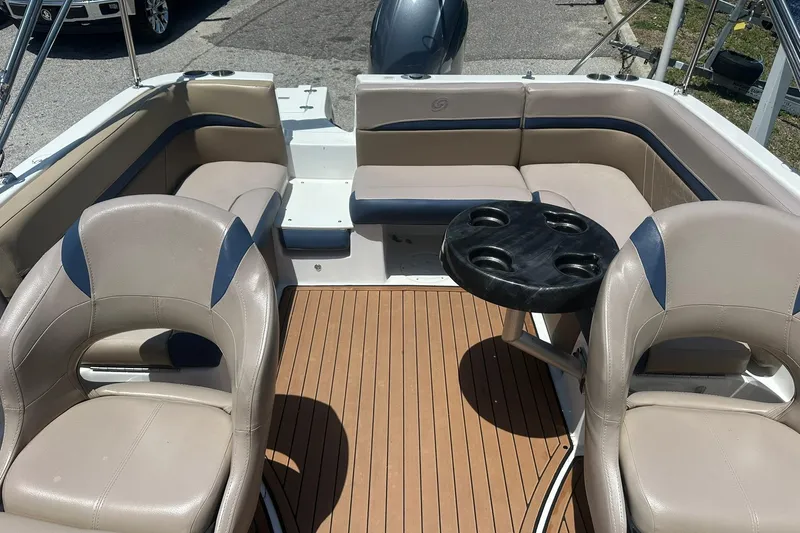 Slide: The Image of 2019 Hurricane Sundeck Sport 218 OB interior with seating and cupholder table. - 21