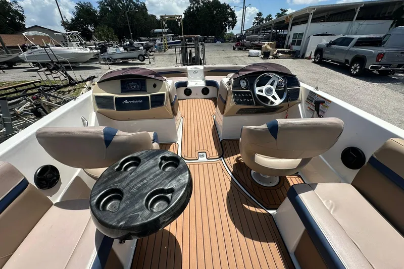 Slide: The Image of 2019 Hurricane Sundeck Sport 218 OB boat interior with seating and steering wheel. - 22