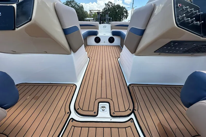 Slide: The Image of 2019 Hurricane Sundeck Sport 218 OB interior with teak flooring and cushioned seating. - 23