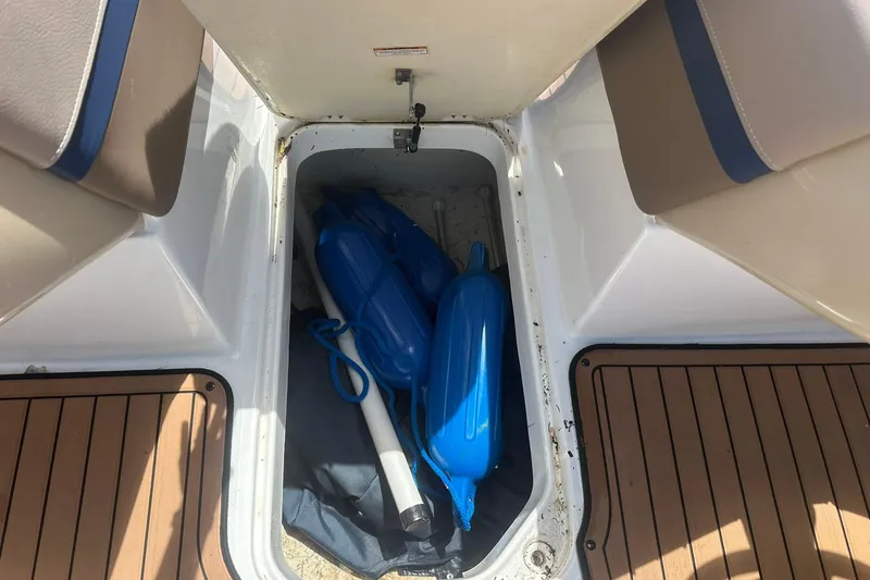 Slide: The Image of Storage compartment of 2019 Hurricane Sundeck Sport 218 OB with blue boat fenders. - 24