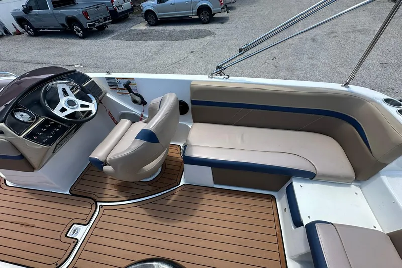 Slide: The Image of 2019 Hurricane Sundeck Sport 218 OB boat interior with seating and steering wheel. - 28