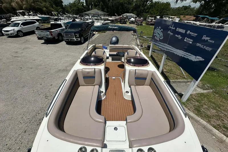 Slide: The Image of 2019 Hurricane Sundeck Sport 218 OB boat with spacious seating, parked in a marina. - 3