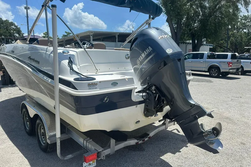Slide: The Image of 2019 Hurricane Sundeck Sport 218 OB boat with Yamaha outboard motor on trailer. - 31
