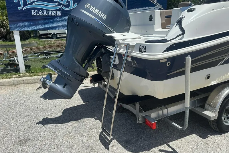 Slide: The Image of 2019 Hurricane Sundeck Sport 218 OB with Yamaha outboard motor on trailer. - 32