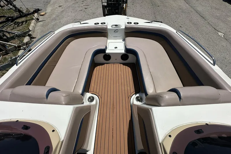 Slide: The Image of 2019 Hurricane Sundeck Sport 218 OB boat interior with beige seating and wood-style flooring. - 6