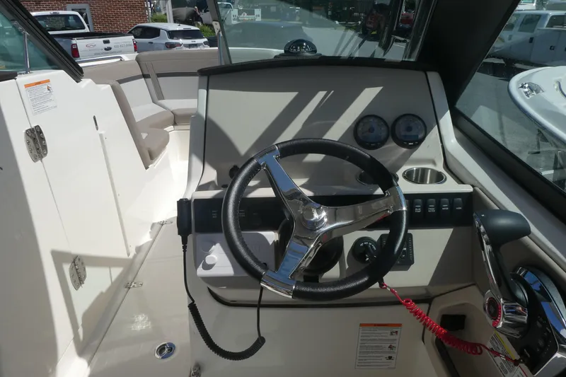 Slide: The Image of 2026 Boston Whaler 240 Vantage boat cockpit with steering wheel and control panel. - 11