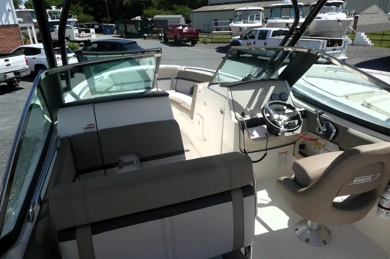 Slide: The Image of 2026 Boston Whaler 240 Vantage boat interior with steering wheel and seating. - 4