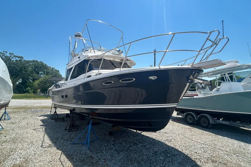 The Image of 2022 Cutwater C-30 CB boat on stands in a sunny outdoor setting. - 1