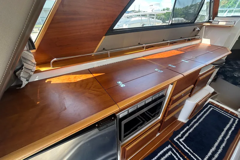 Slide: The Image of 2022 Cutwater C-30 CB yacht interior with sleek wooden cabinetry and modern appliances. - 10