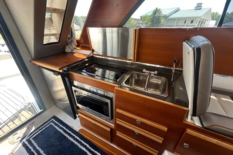Slide: The Image of Interior of 2022 Cutwater C-30 CB yacht featuring a compact kitchen area. - 11