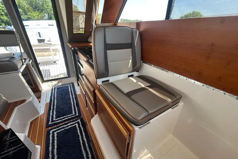 Slide: The Image of Interior of 2022 Cutwater C-30 CB boat with cushioned seating and wooden accents. - 12