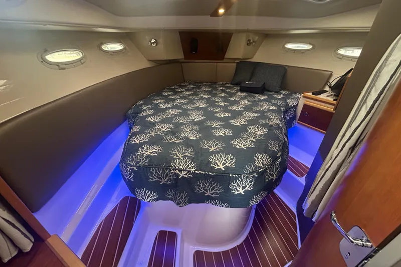 Slide: The Image of 2022 Cutwater C-30 CB cabin interior with cozy bed and ambient lighting. - 13
