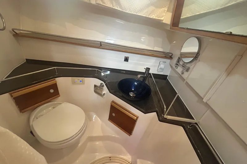Slide: The Image of 2022 Cutwater C-30 CB boat bathroom with modern sink and compact design. - 14