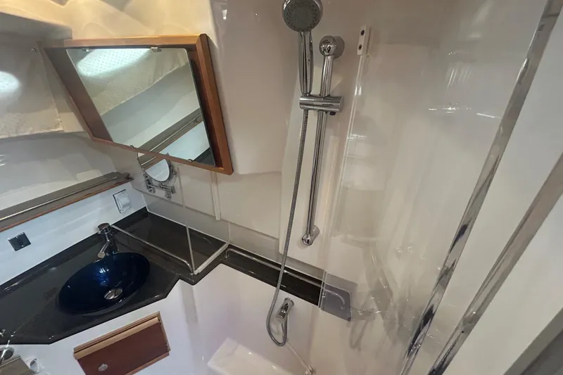 Slide: The Image of 2022 Cutwater C-30 CB bathroom with modern sink, mirror, and shower fixtures. - 15