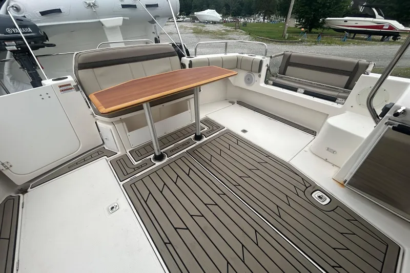 Slide: The Image of 2022 Cutwater C-30 CB boat deck with seating and wooden table. - 16