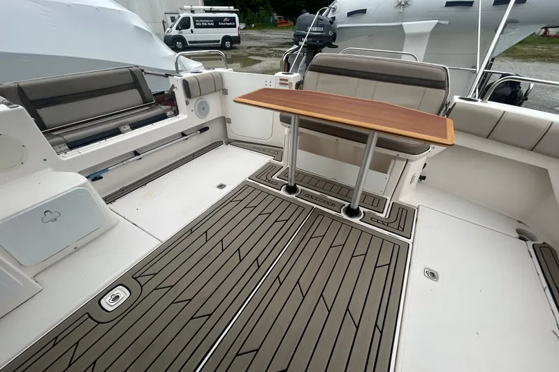 Slide: The Image of 2022 Cutwater C-30 CB boat interior with seating and wooden table on deck. - 17