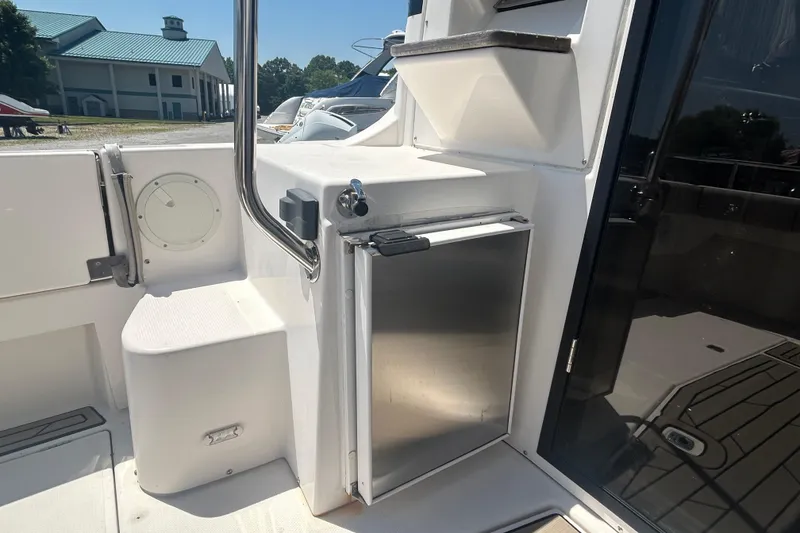 Slide: The Image of 2022 Cutwater C-30 CB boat interior with stainless steel fridge and seating area. - 4