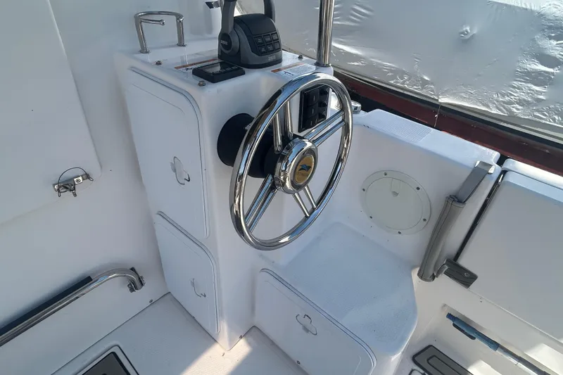 Slide: The Image of Steering console of 2022 Cutwater C-30 CB boat with chrome wheel and controls. - 5