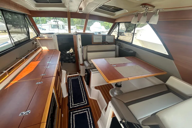 Slide: The Image of Interior of 2022 Cutwater C-30 CB boat with dining area and wooden cabinetry. - 7