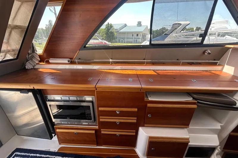 Slide: The Image of 2022 Cutwater C-30 CB yacht interior with wooden cabinetry and built-in microwave. - 9
