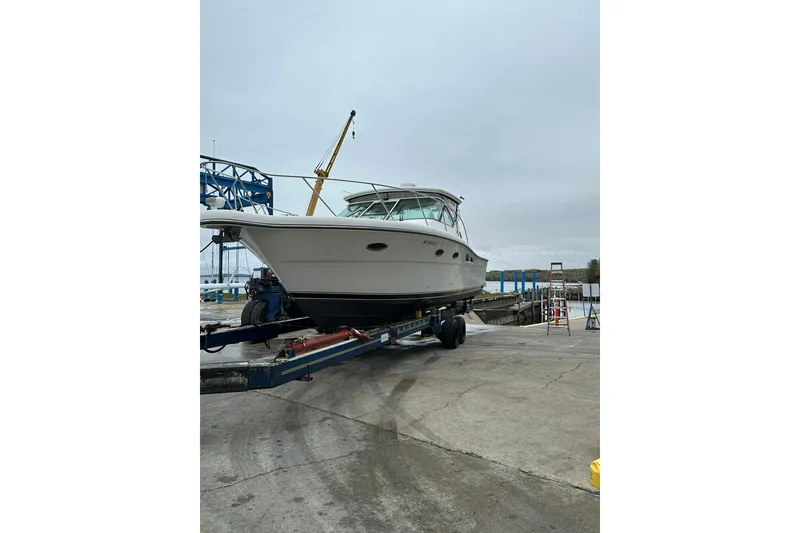 Slide: The Image of 2004 Tiara Yachts 3200 Open on trailer at marina, overcast sky. - 2