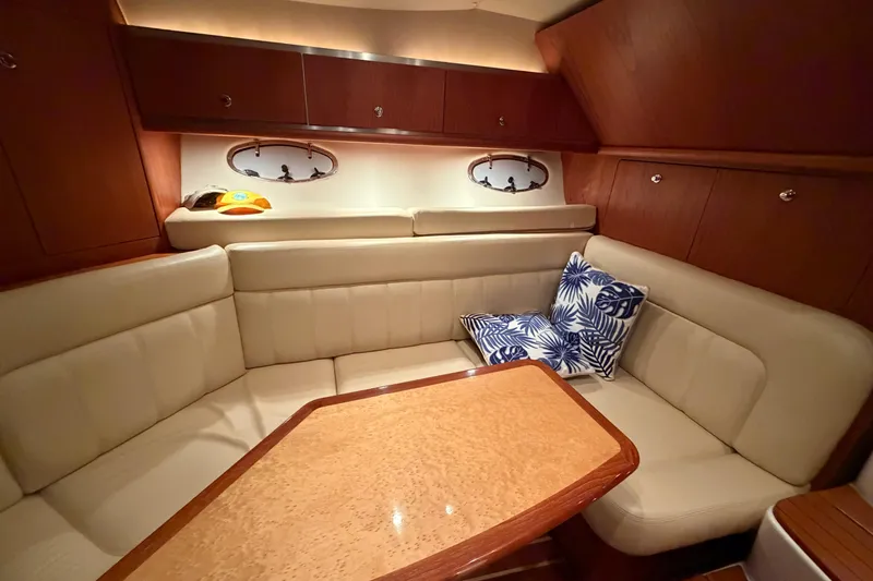 Slide: The Image of Luxurious interior of 2004 Tiara Yachts 3200 Open with plush seating and elegant wood finishes. - 22