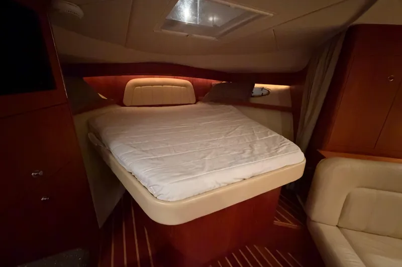 Slide: The Image of Luxurious cabin interior of 2004 Tiara Yachts 3200 Open with cozy bed. - 25