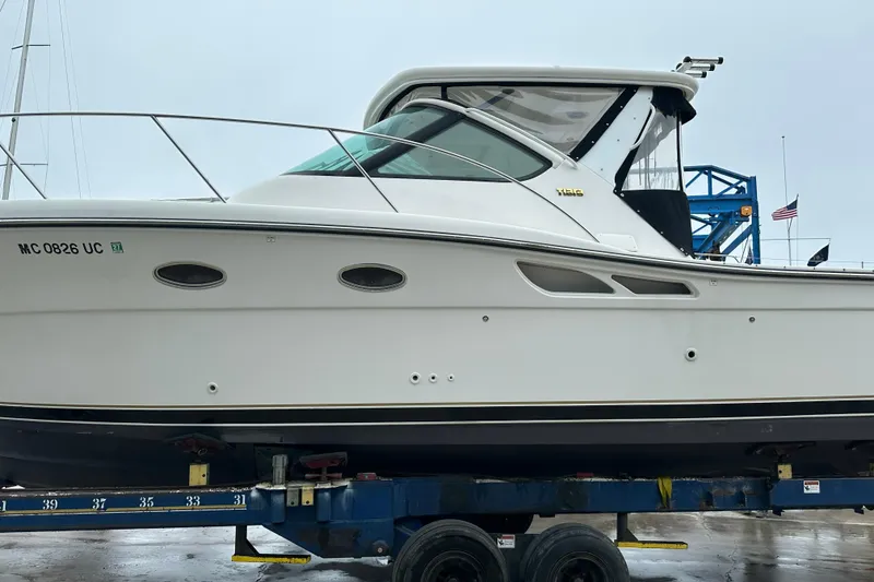 Slide: The Image of 2004 Tiara Yachts 3200 Open on trailer, side view, showcasing sleek design and structure. - 3